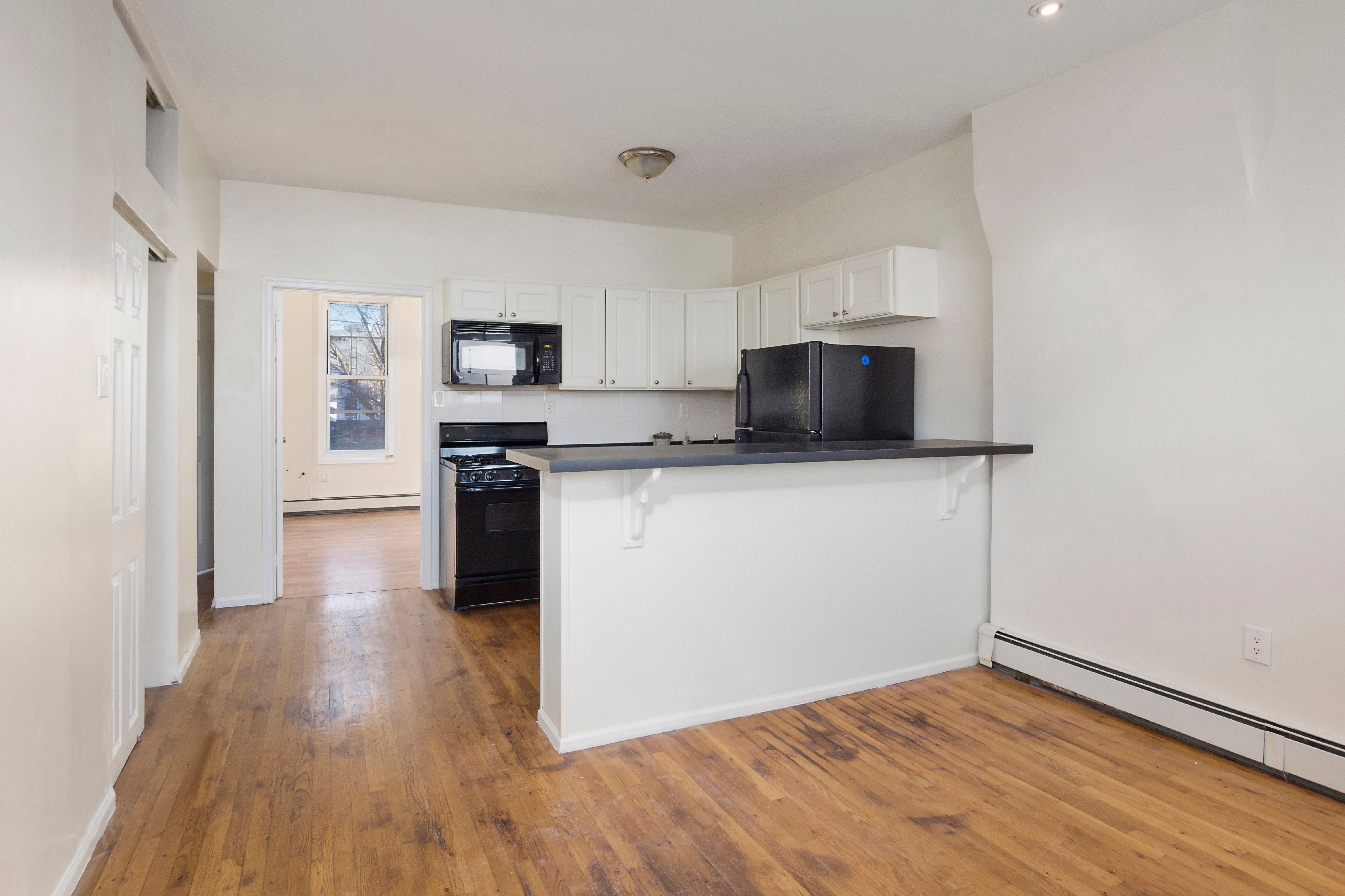 148 29th Street Brooklyn, NY 11232 - Photo 18 of 31 a kitchen with granite countertop a stove and a microwave