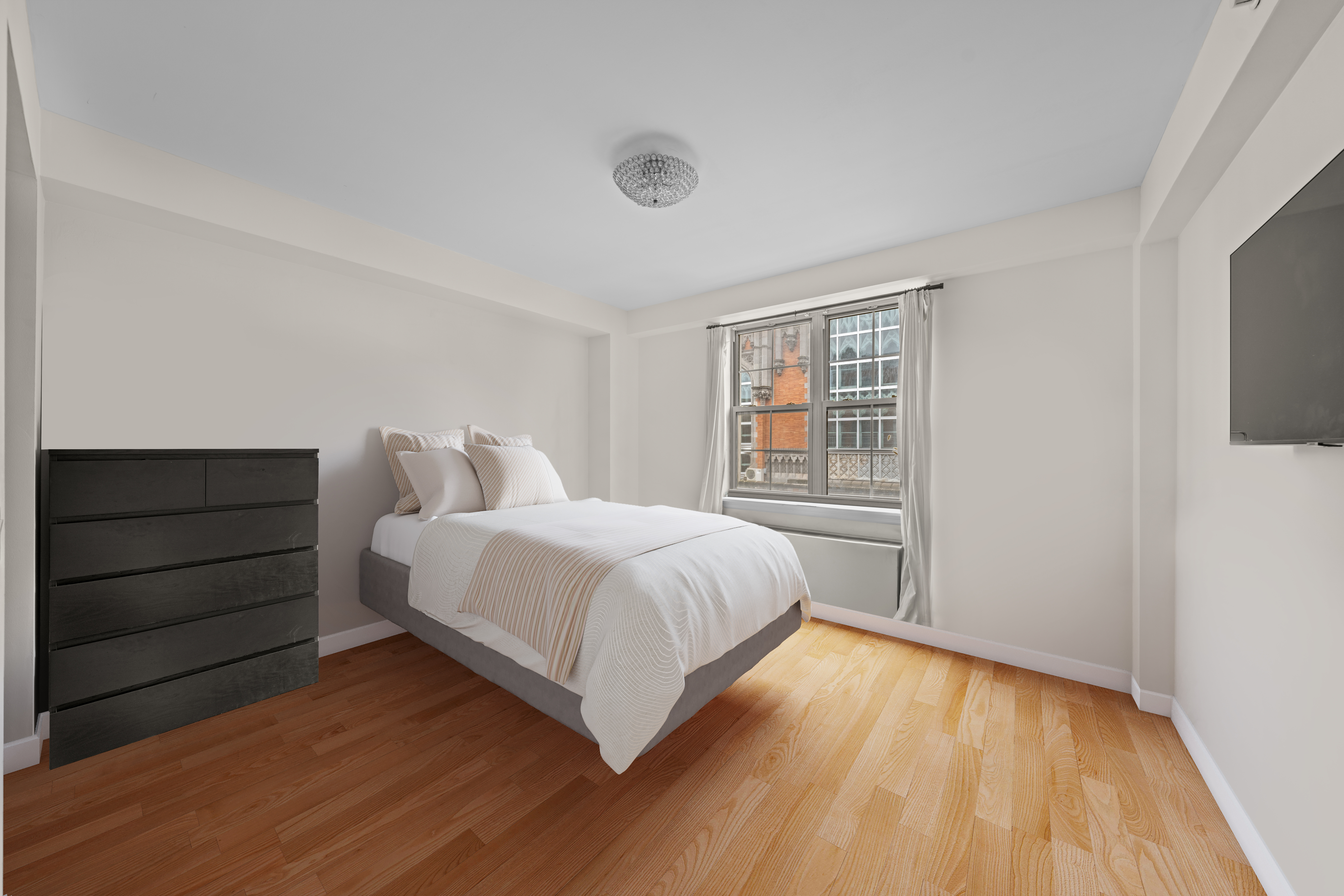 163 St Nicholas Avenue, Unit 4H Manhattan, NY 10026 - Photo 8 of 16 a bedroom with a bed and a window