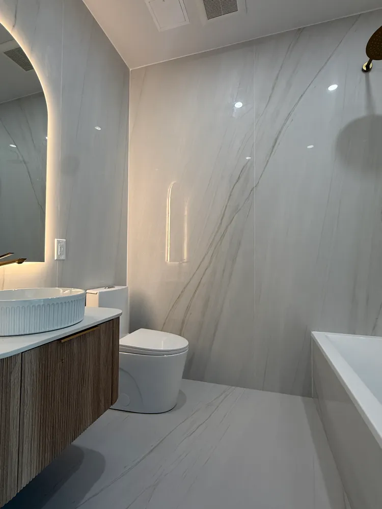 a bathroom with a toilet sink and mirror