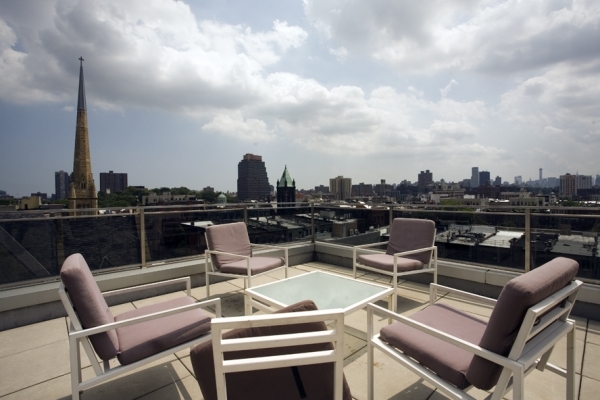 117 West 123rd Street, Unit 4B Manhattan, NY 10027 - Photo 13 of 16 a view of a terrace with seating area