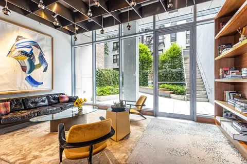 a living room with furniture and a floor to ceiling window