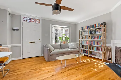 a living room with furniture and a book shelf