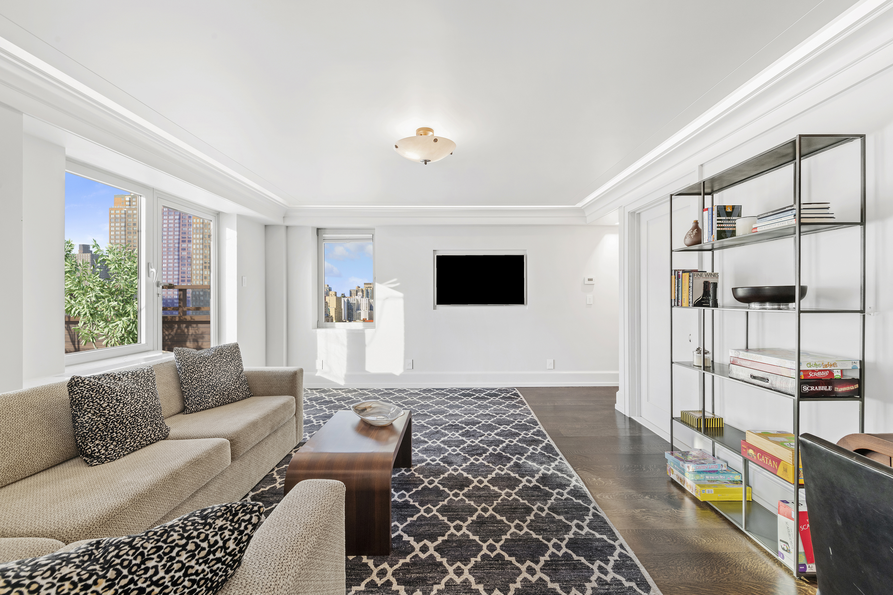 180 East End Avenue, Unit 15E Manhattan, NY 10128 - Photo 15 of 31 a living room with furniture and a flat screen tv