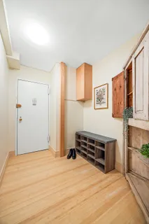 a view of a bedroom with furniture and cabinet