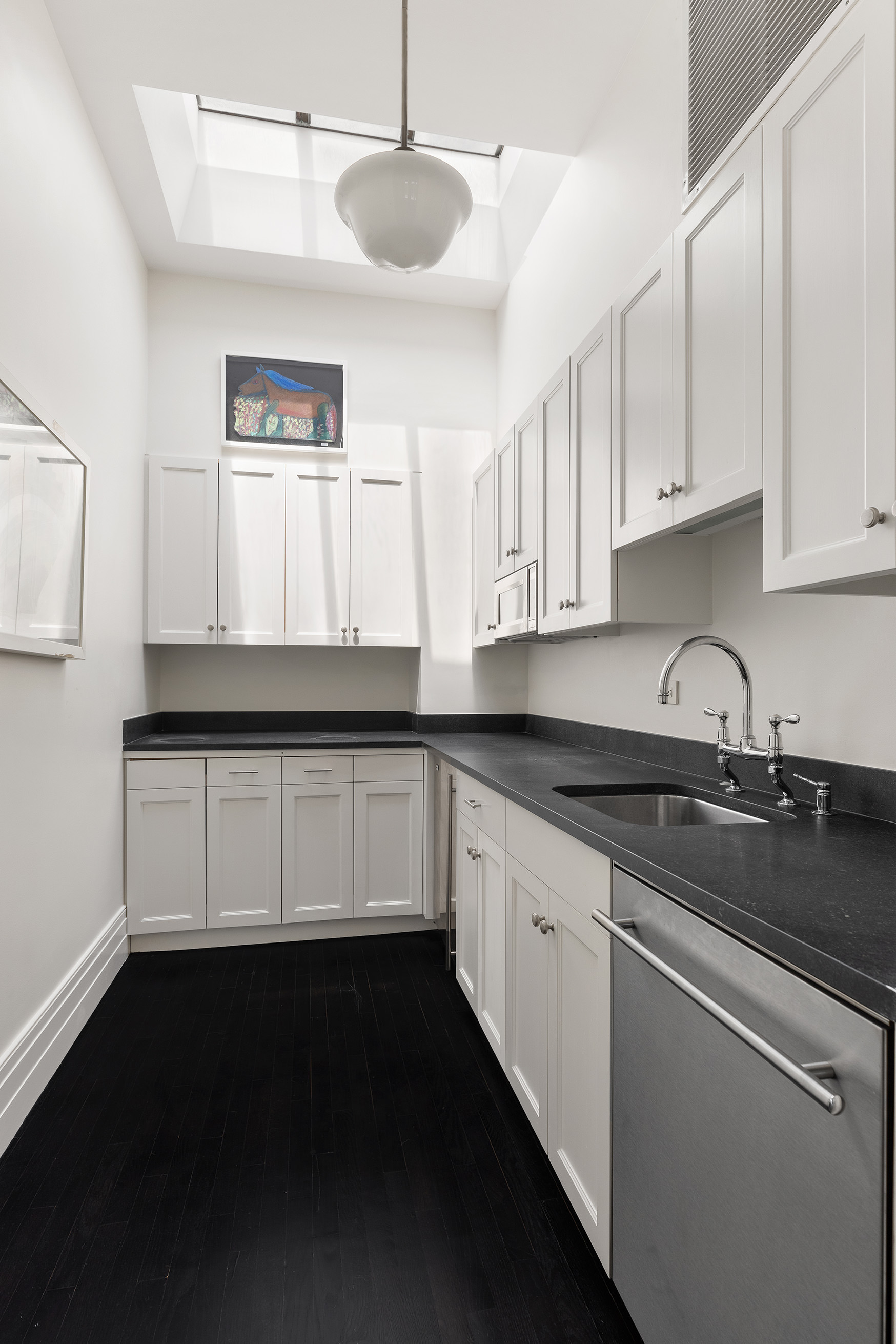 135 West 77th Street Manhattan, NY 10024 - Photo 28 of 32 a kitchen with granite countertop white cabinets white appliances a sink and a dishwasher