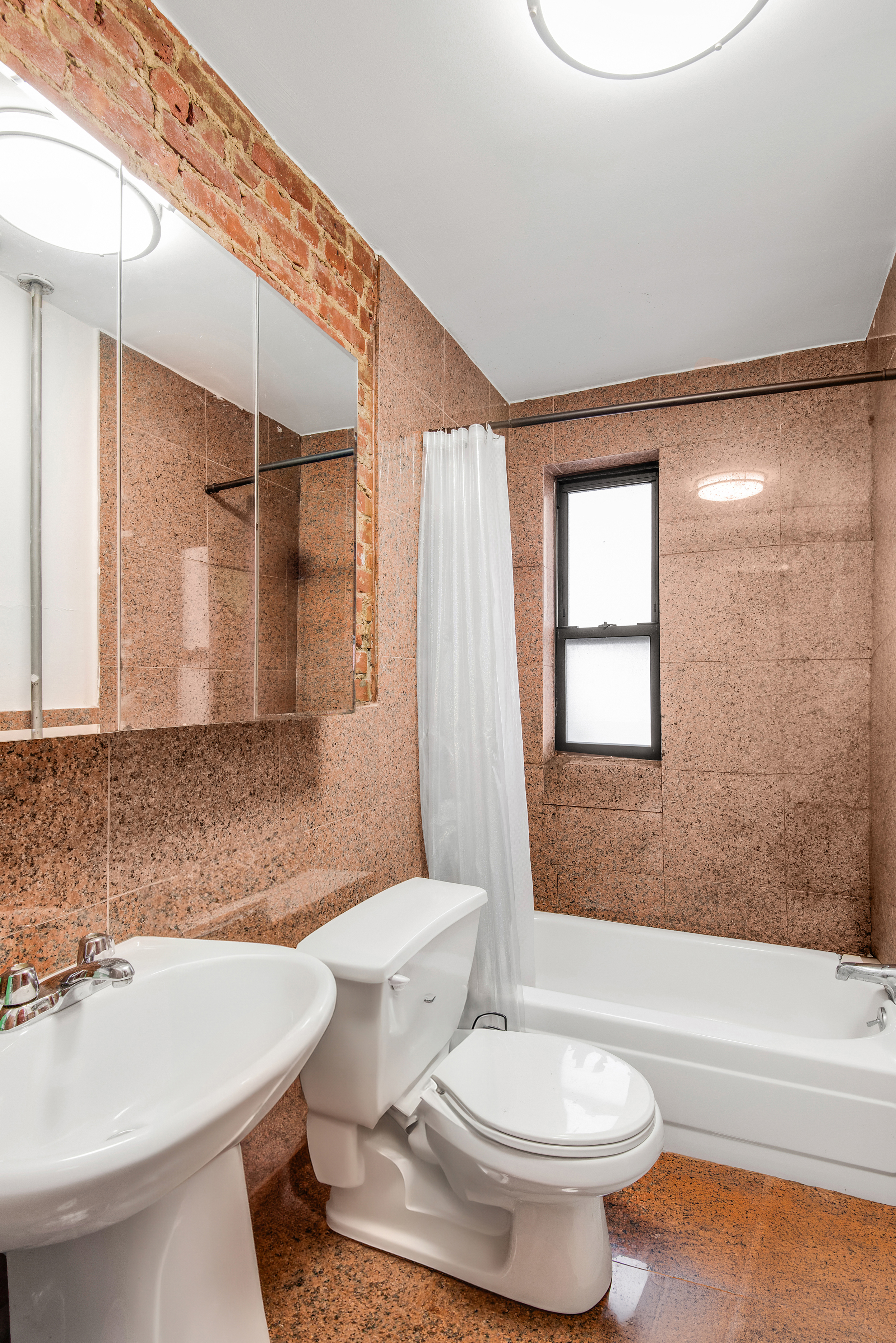 1392 Madison Avenue, Unit 28 Manhattan, NY 10128 - Photo 10 of 10 a bathroom with a toilet a sink and bathtub