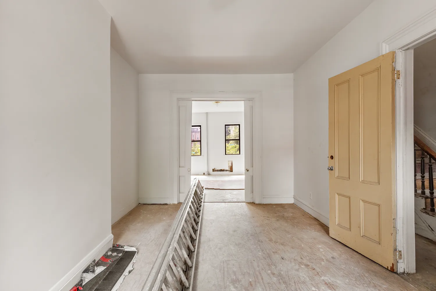 a view of hallway with wooden floor