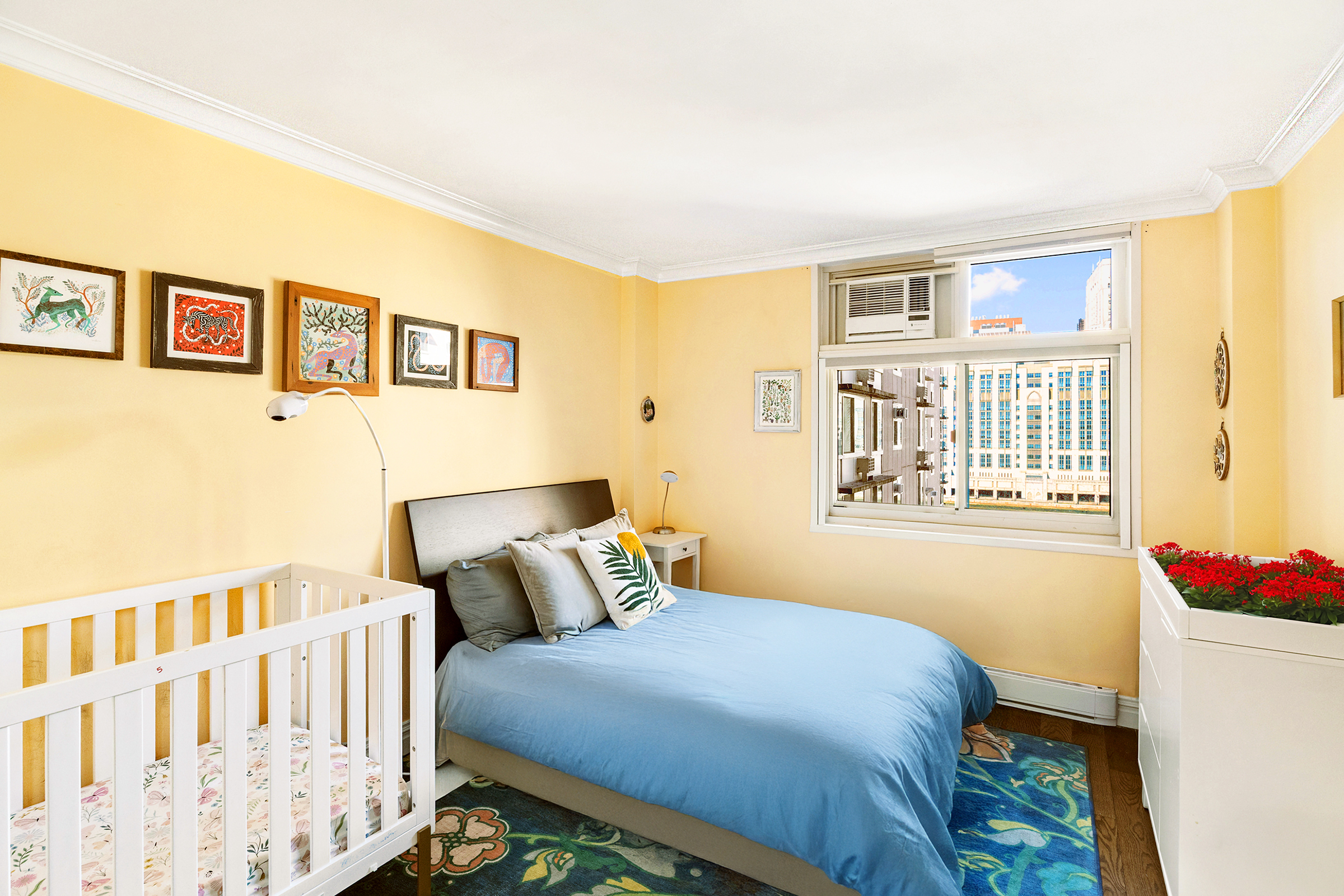 555 Main Street, Unit 1115 Manhattan, NY 10044 - Photo 6 of 9 a bedroom with a bed and wooden floor