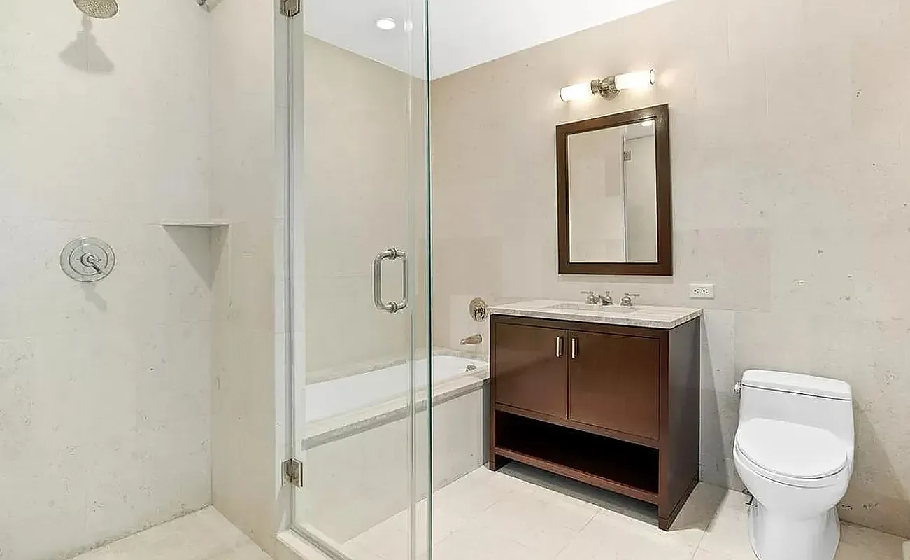 100 Riverside Boulevard, Unit 8B Manhattan, NY 10069 - Photo 4 of 11 a bathroom with a toilet sink and mirror