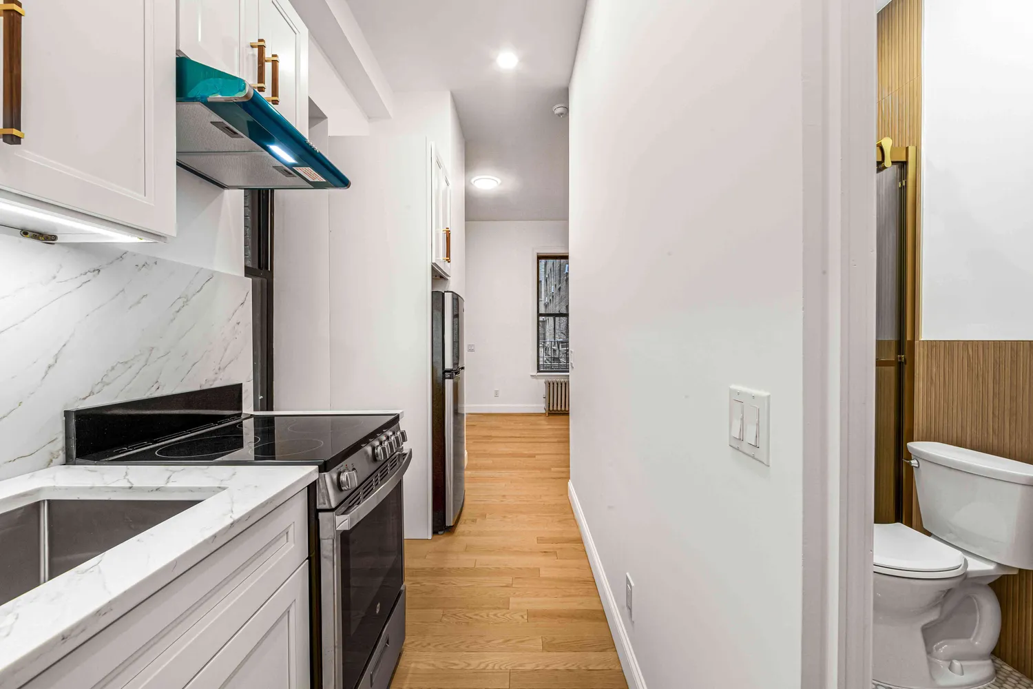 a view of a kitchen from the corridor