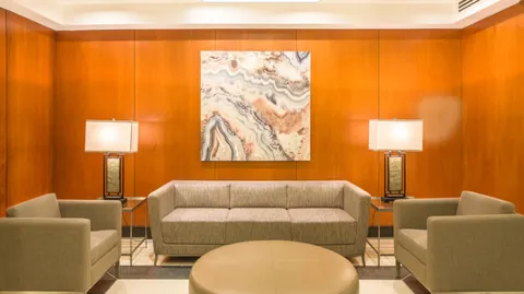 a living room with furniture and a lamp