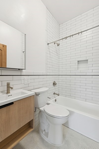 144 Somers Street, Unit 2 Brooklyn, NY 11233 - Photo 5 of 10 a bathroom with a sink a toilet and shower