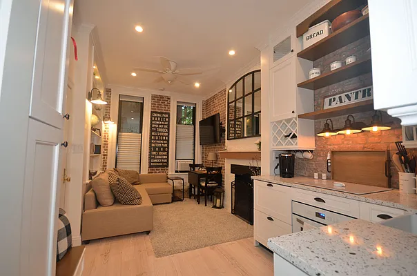 88 Horatio Street, Unit 1C Manhattan, NY 10014 - Photo 2 of 9 a living room with furniture and flat screen tv