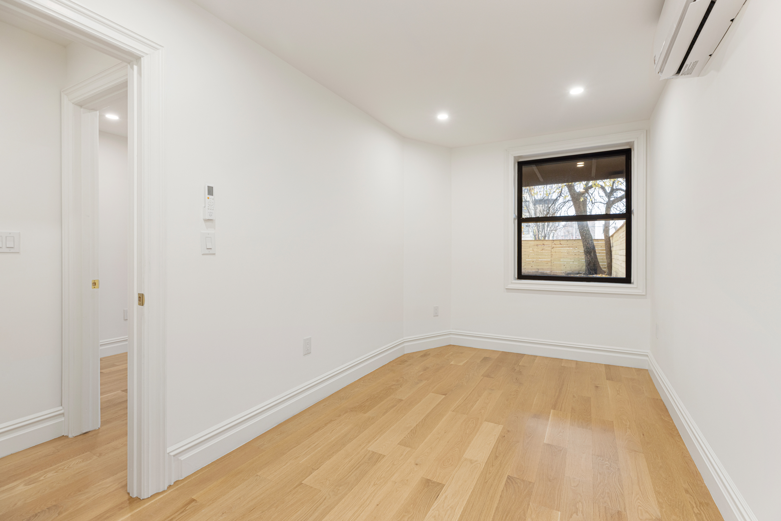 15 Verona Place, Unit GARDEN Brooklyn, NY 11216 - Photo 8 of 14 wooden floor in an empty room with a window