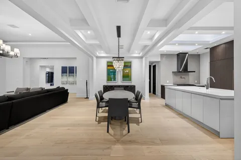 a kitchen with a table chairs refrigerator and cabinets