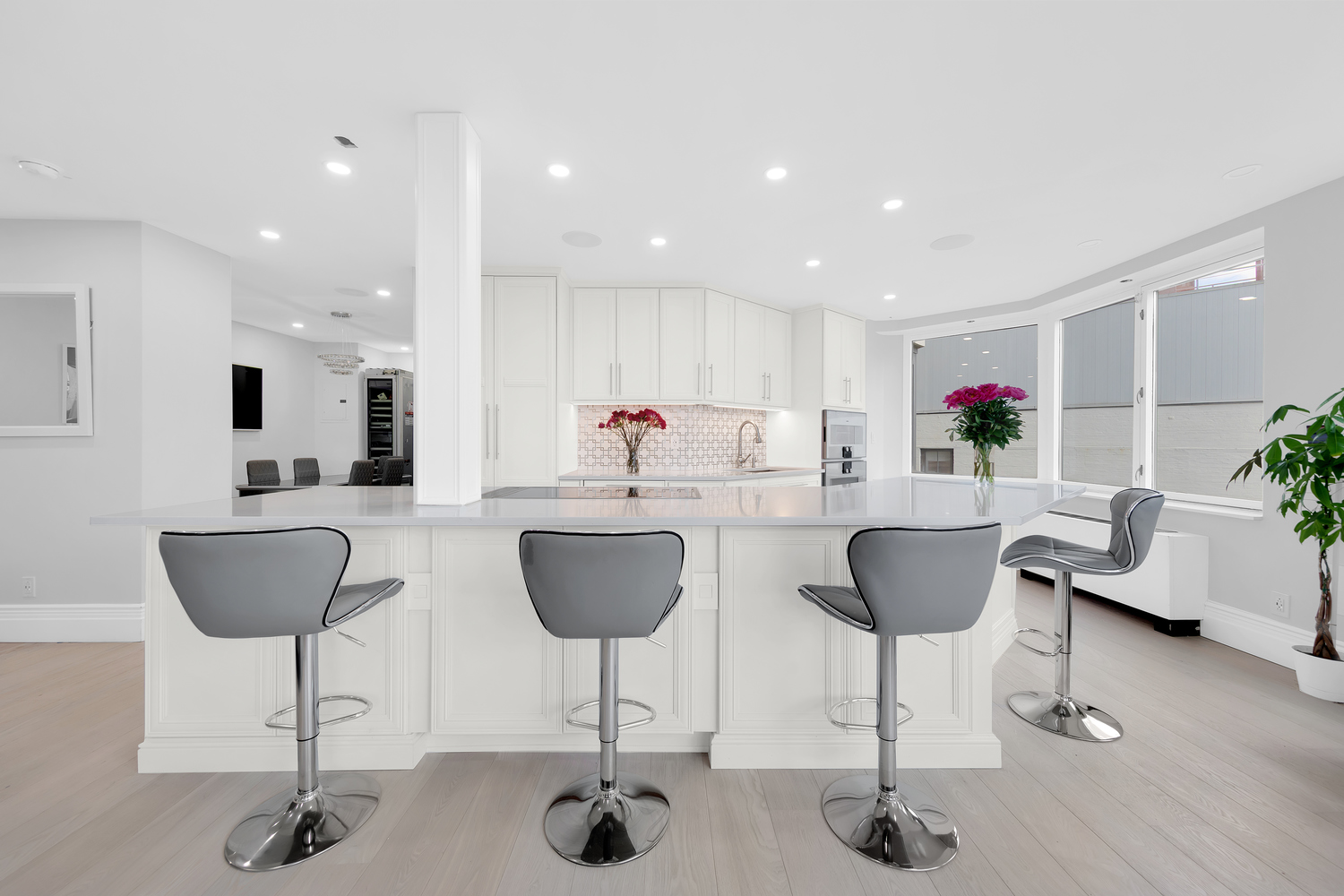 415 East 37th Street, Unit 9JK Manhattan, NY 10016 - Photo 4 of 28 a kitchen with stainless steel appliances kitchen island granite countertop a dining table chairs and a view of kitchen