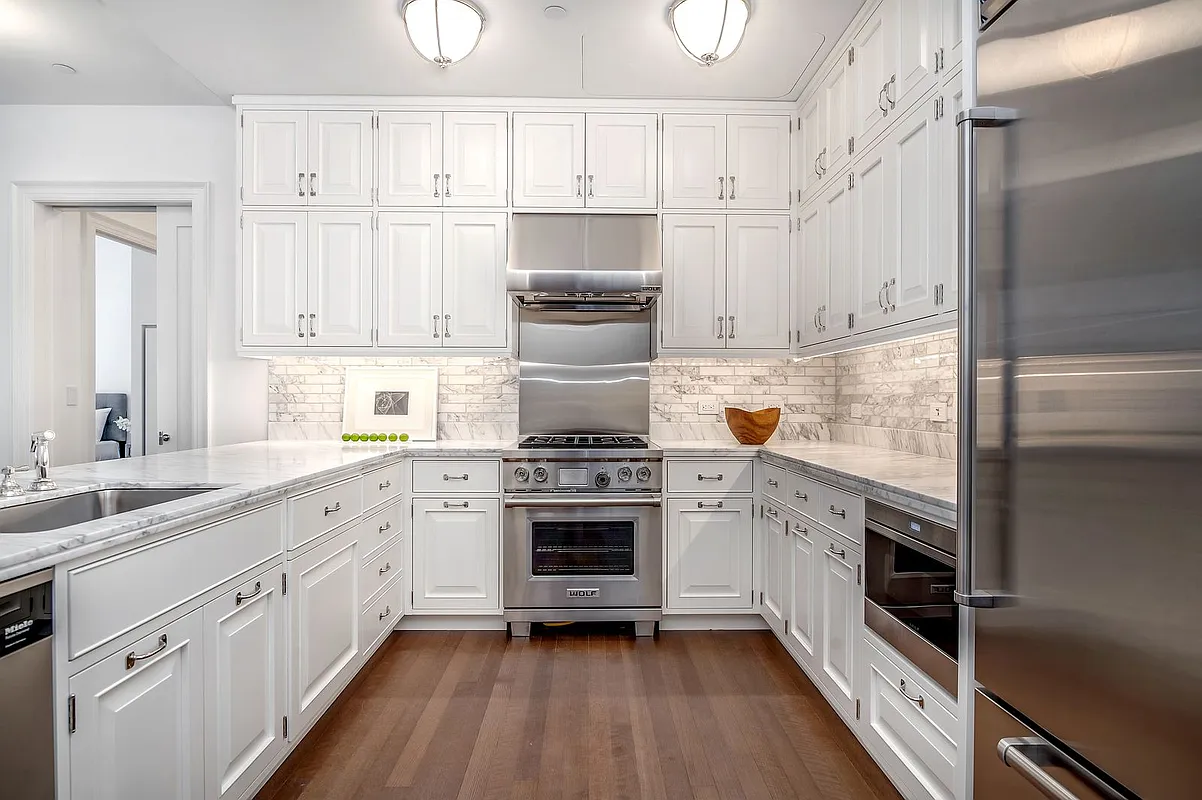 160 West 12th Street, Unit 26 Manhattan, NY 10011 - Photo 2 of 10 a kitchen with cabinets stainless steel appliances and a counter space