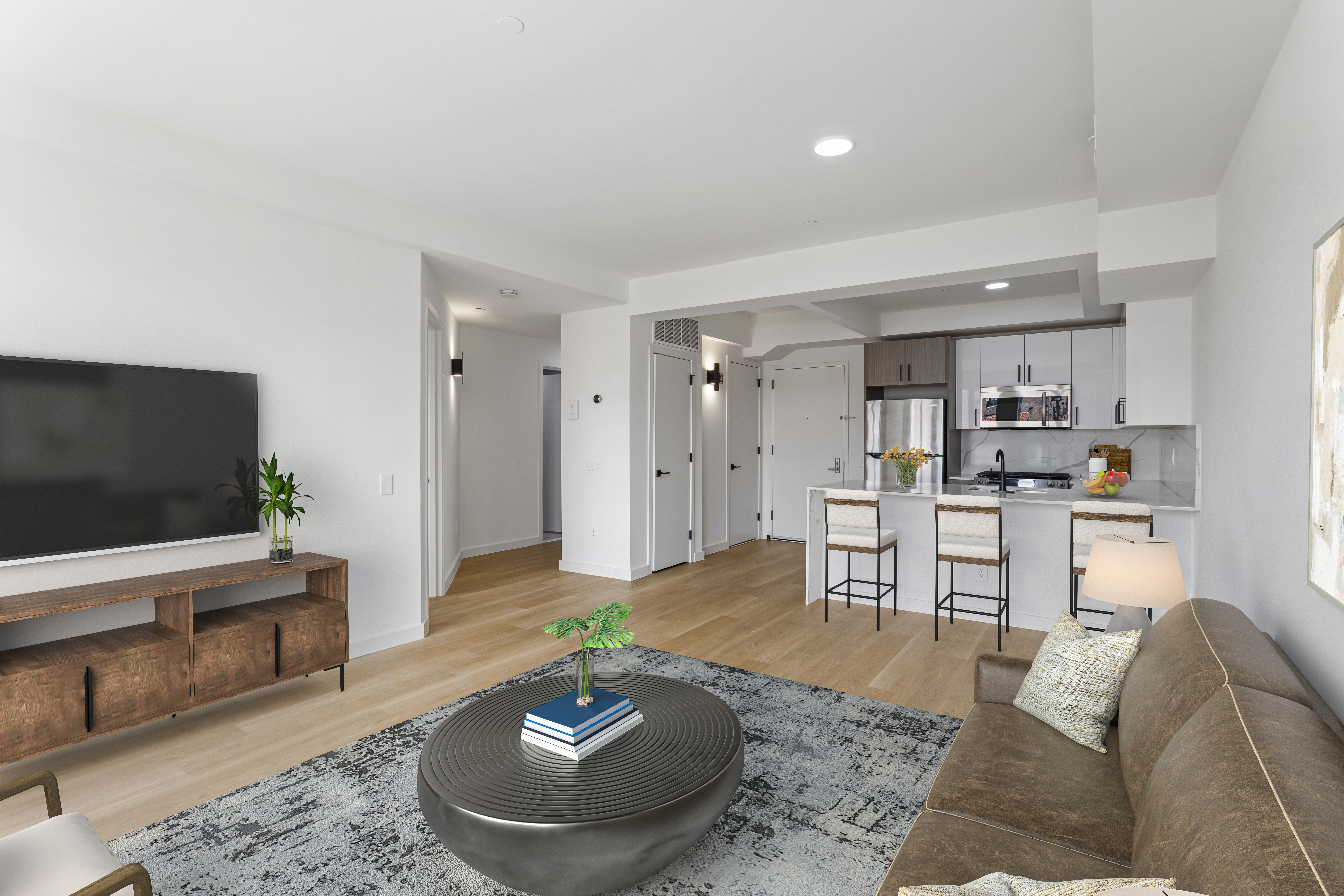 3144 Emmons Avenue, Unit 102 Brooklyn, NY 11235 - Photo 1 of 12 a living room with furniture and a flat screen tv