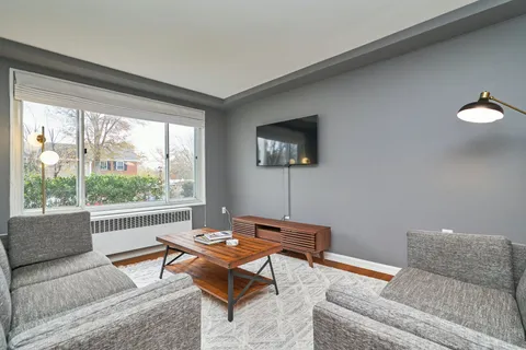 a living room with furniture and a large window