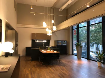 a kitchen with stainless steel appliances a sink and a refrigerator