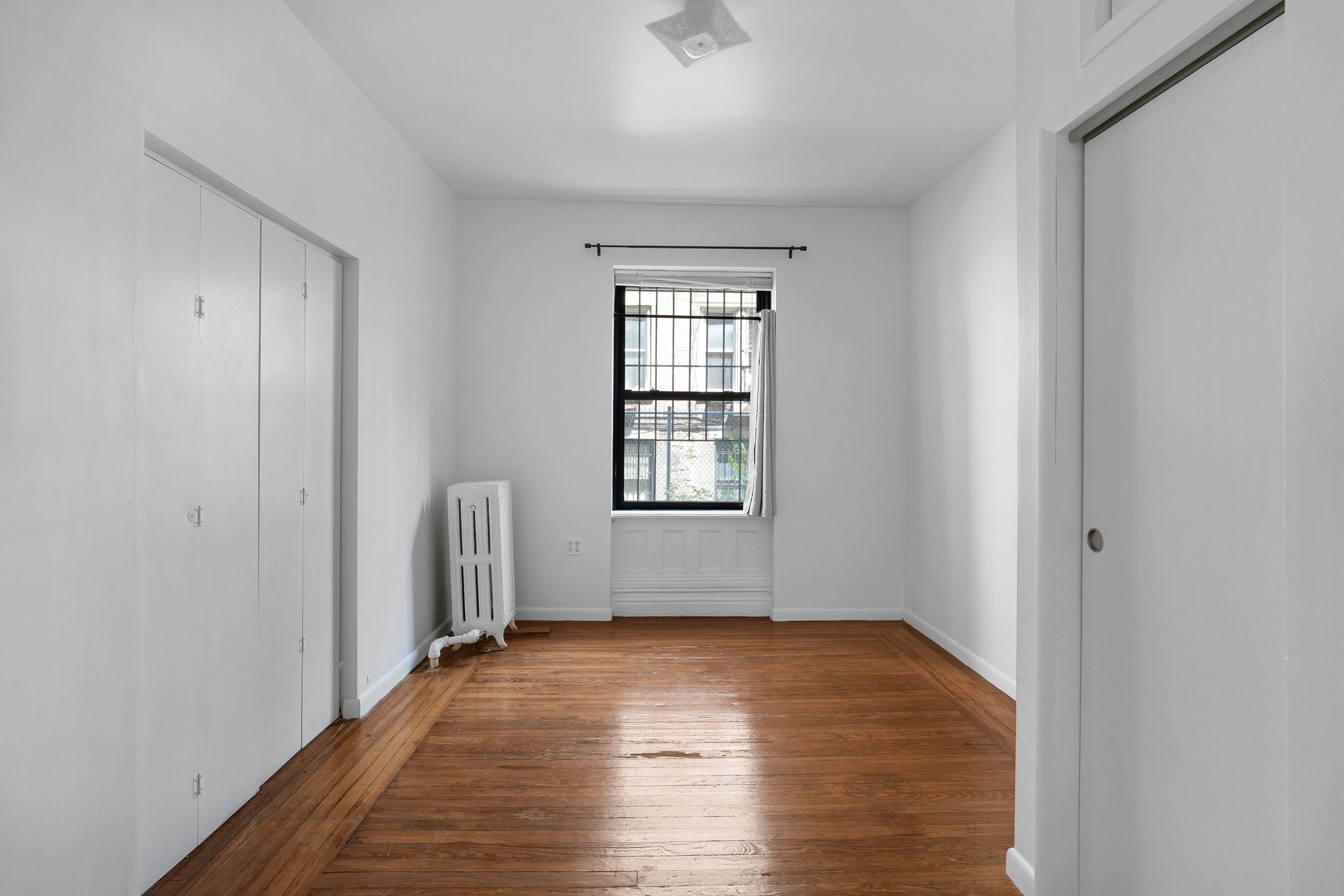 507 West 111th Street, Unit 3 Manhattan, NY 10025 - Photo 6 of 11 a view of empty room with wooden floor and fan