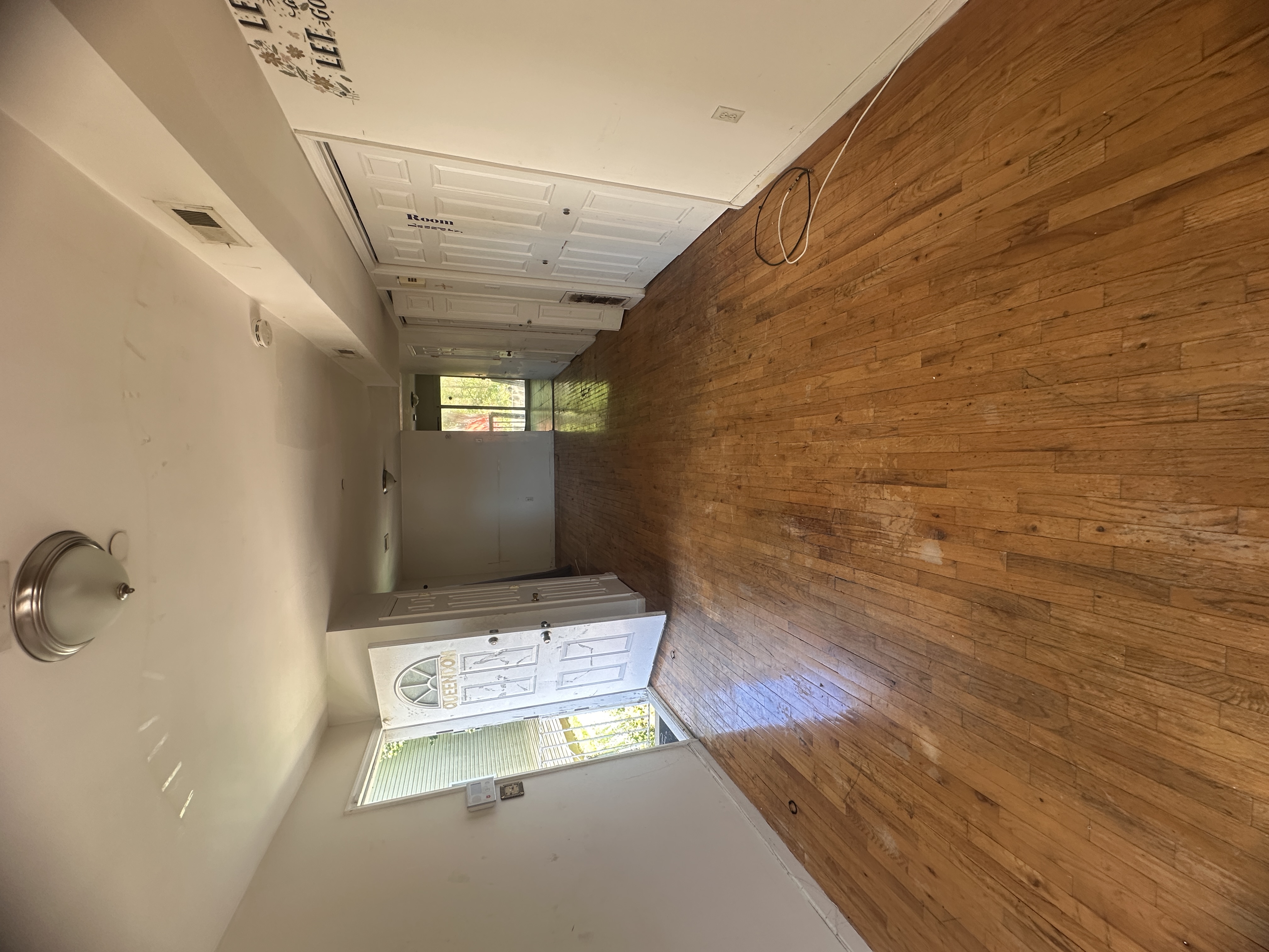 165 Brighton Avenue Staten Island, NY 10301 - Photo 2 of 8 an empty room with wooden floor and windows