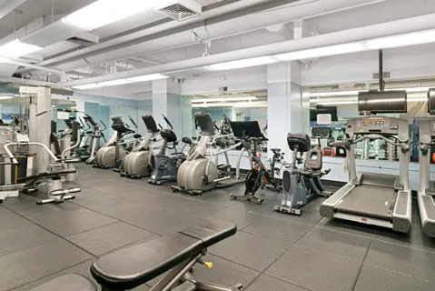 a room with gym equipment and a view of living room