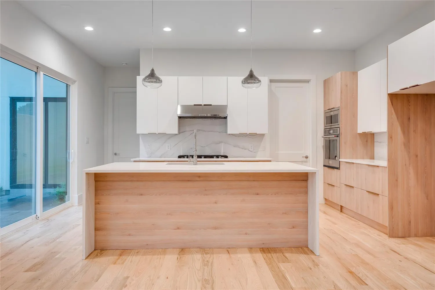 a view of kitchen with stainless steel appliances cabinets