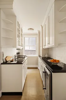 a kitchen with stainless steel appliances a sink stove and cabinets