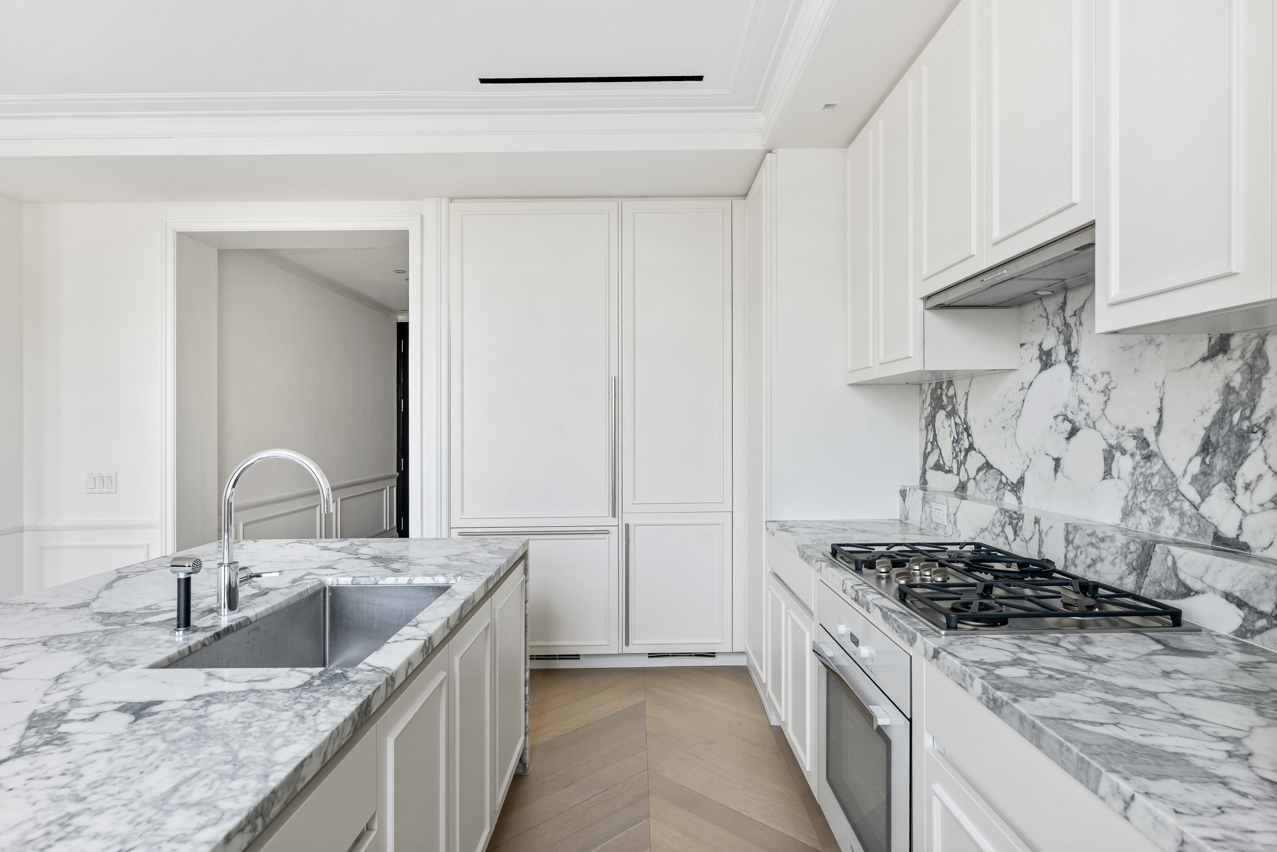 108 Leonard Street, Unit 12F Manhattan, NY 10013 - Photo 4 of 15 a kitchen with granite countertop a sink stove and cabinets