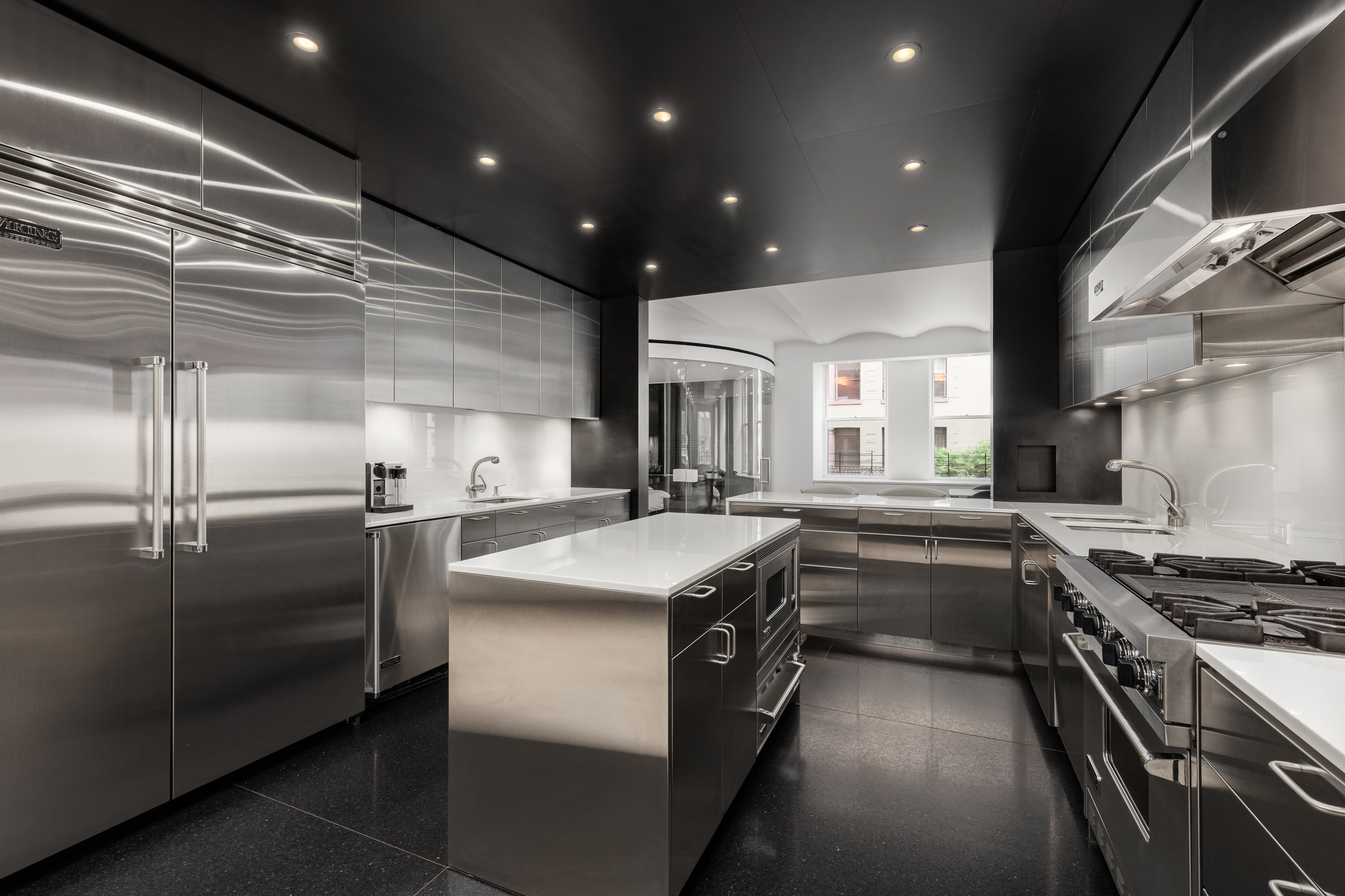 55 Hudson Street, Unit 3BCD Manhattan, NY 10013 - Photo 7 of 21 a kitchen with kitchen island stainless steel appliances a sink stove and refrigerator