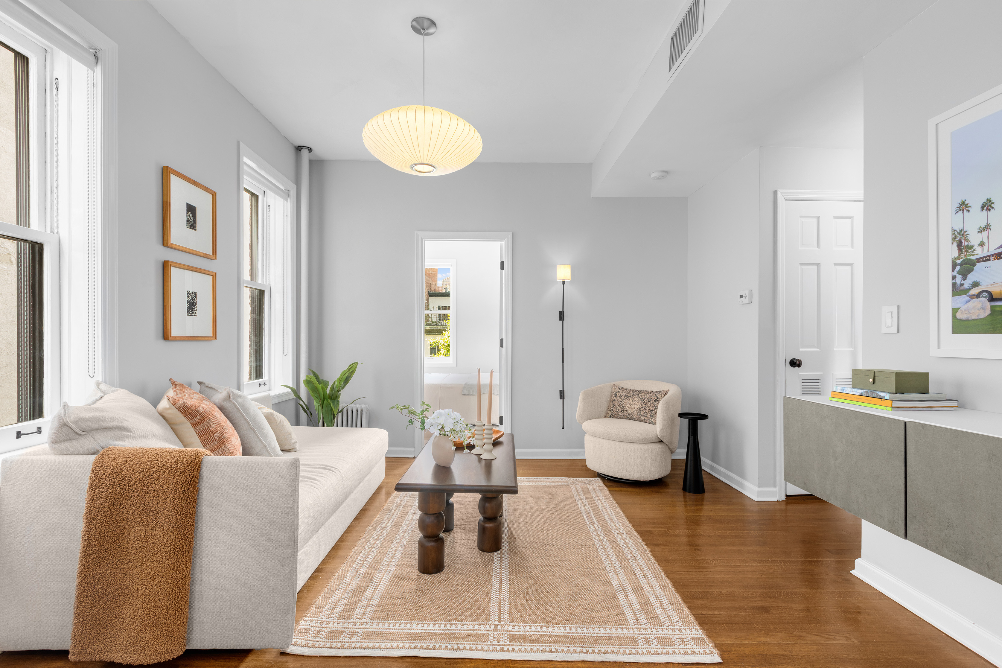 a living room with furniture and wooden floor