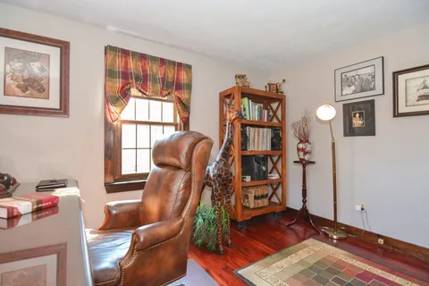 a view of a livingroom with furniture and a workspace