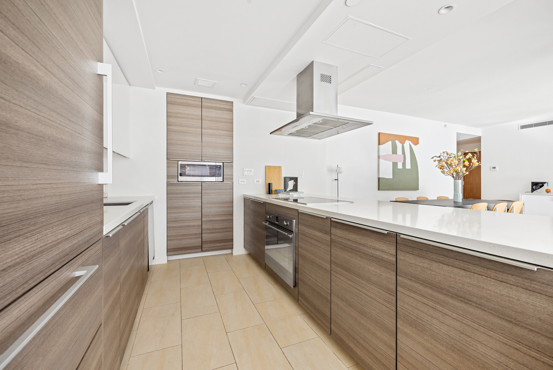 151 West 21st Street, Unit 10A Manhattan, NY 10011 - Photo 8 of 26 a kitchen with stainless steel appliances a sink and cabinets