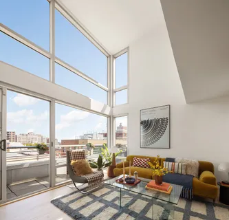 a living room with furniture and a floor to ceiling window