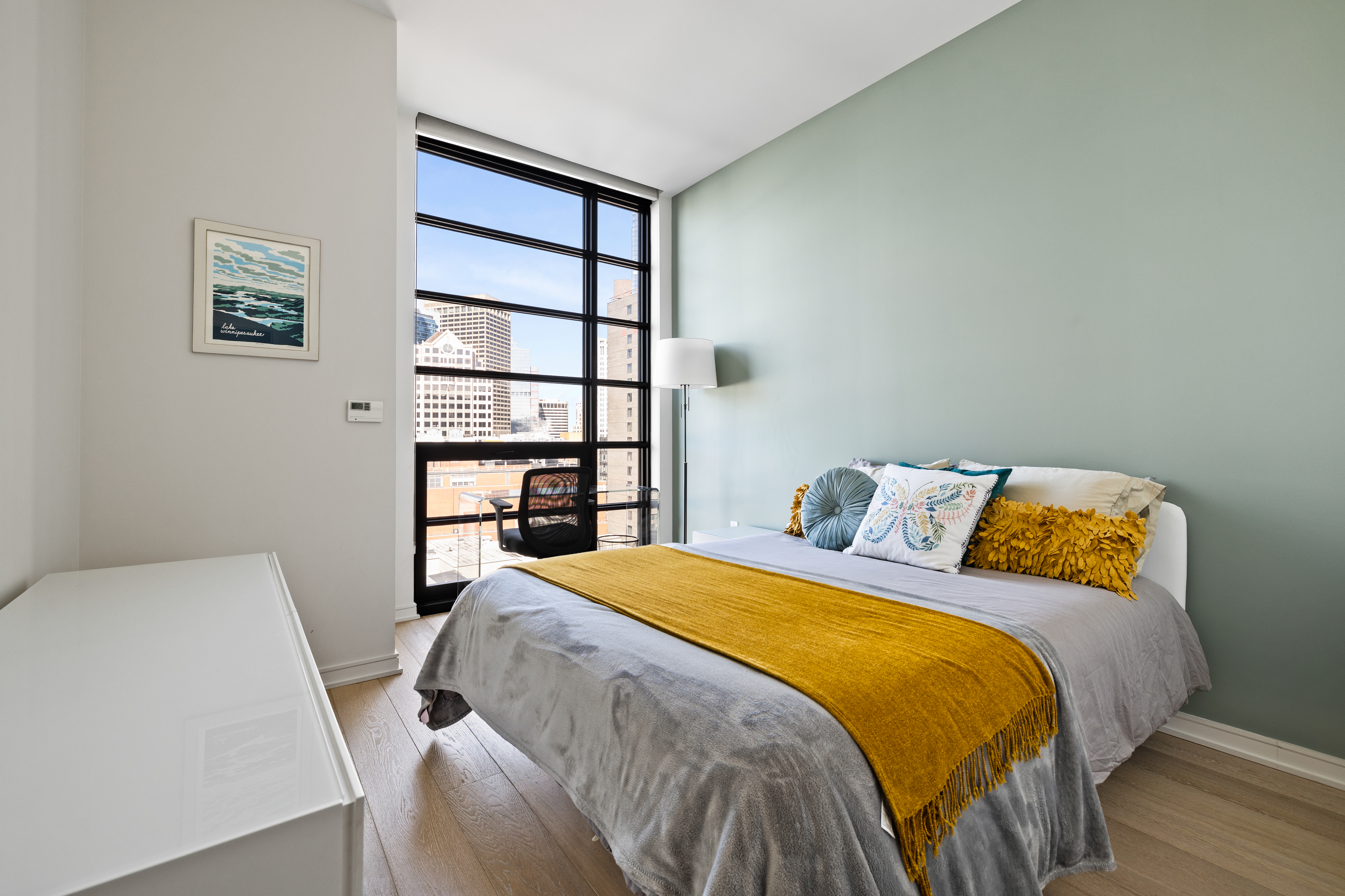 580 Washington Street, Unit PH5 Boston, MA 02111 - Photo 6 of 12 a bedroom with a bed and a closet