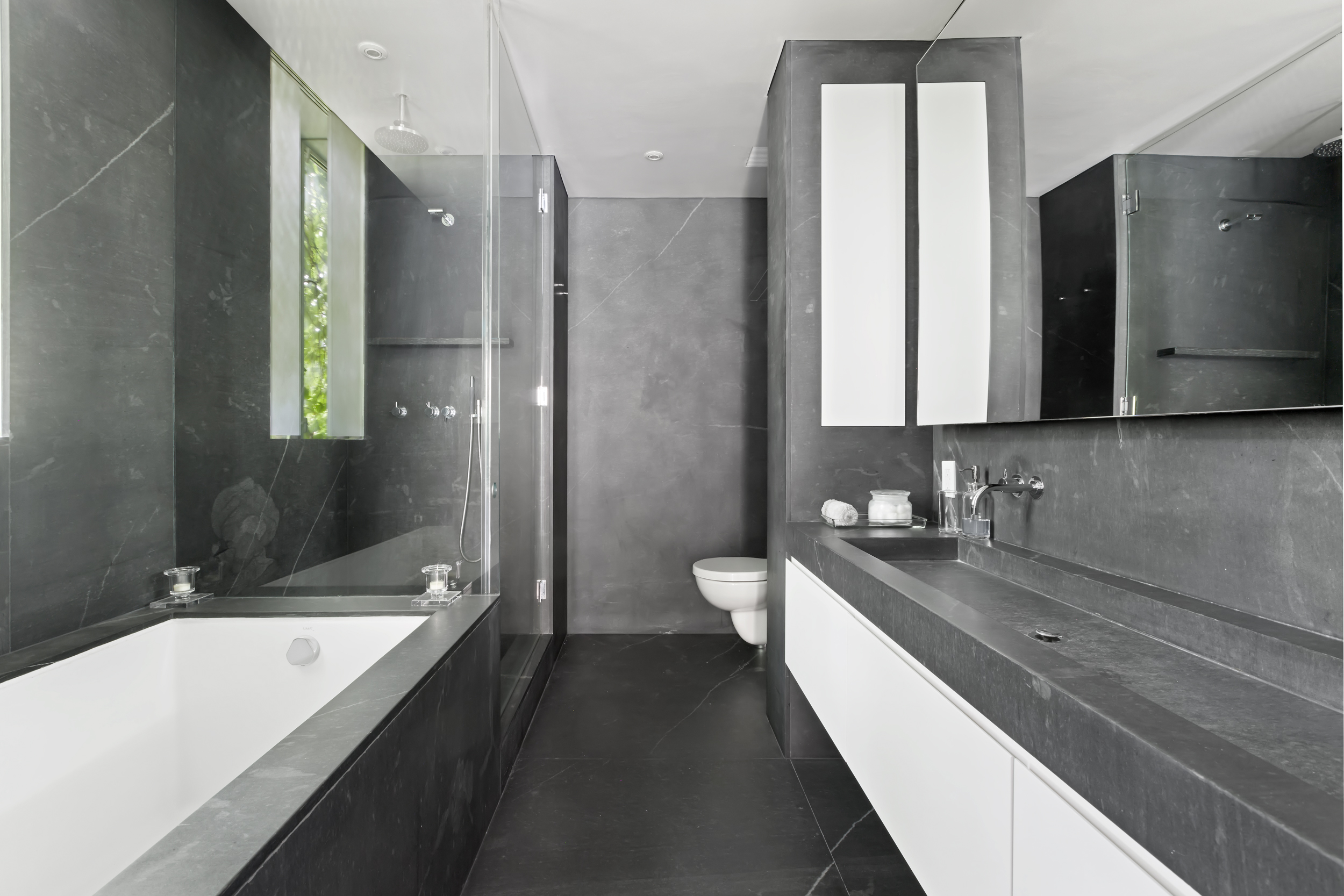 744 Greenwich Street, Unit 4 Manhattan, NY 10014 - Photo 27 of 34 a bathroom with a double vanity sink and mirror with bathtub