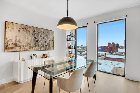 a dining room with furniture and a chandelier
