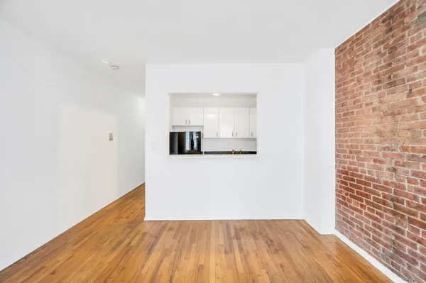 a view of a room with wooden floor
