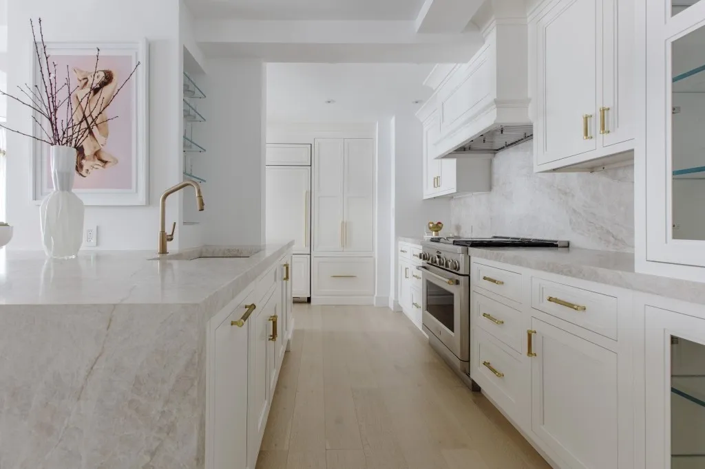 a kitchen with stainless steel appliances granite countertop a sink and a stove top oven