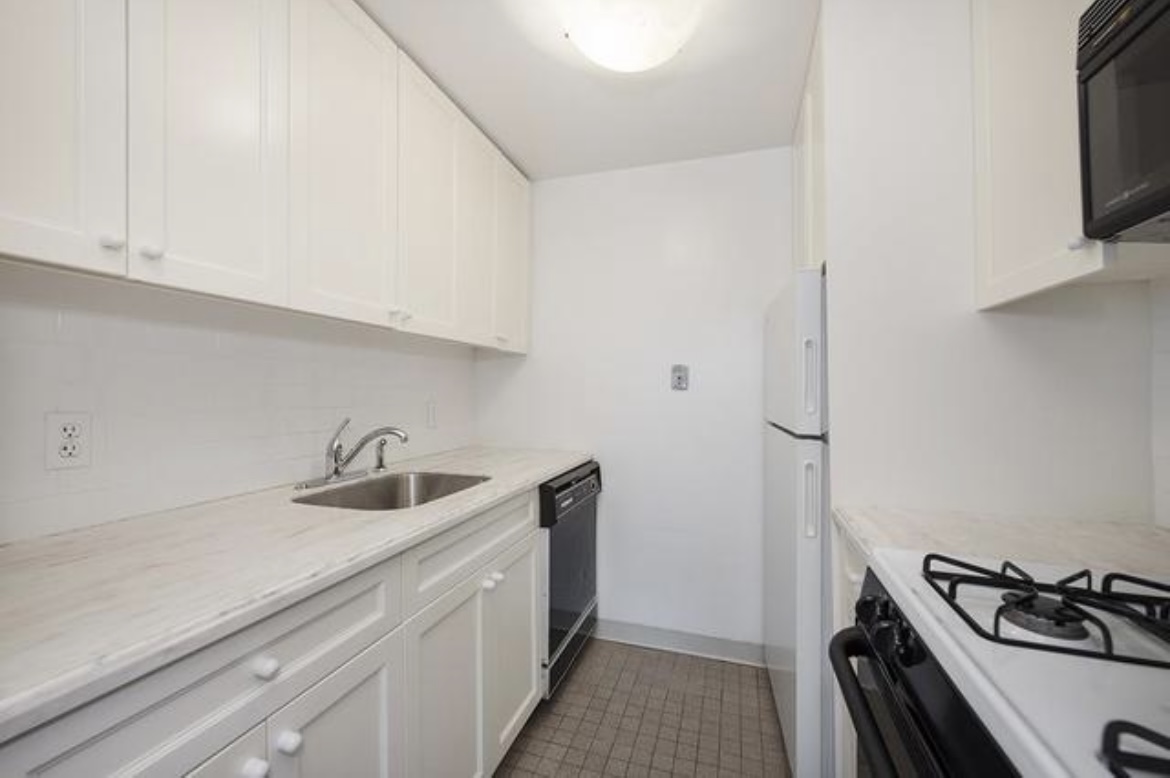201 West 74th Street, Unit 16A Manhattan, NY 10023 - Photo 4 of 13 a kitchen with a sink and cabinets