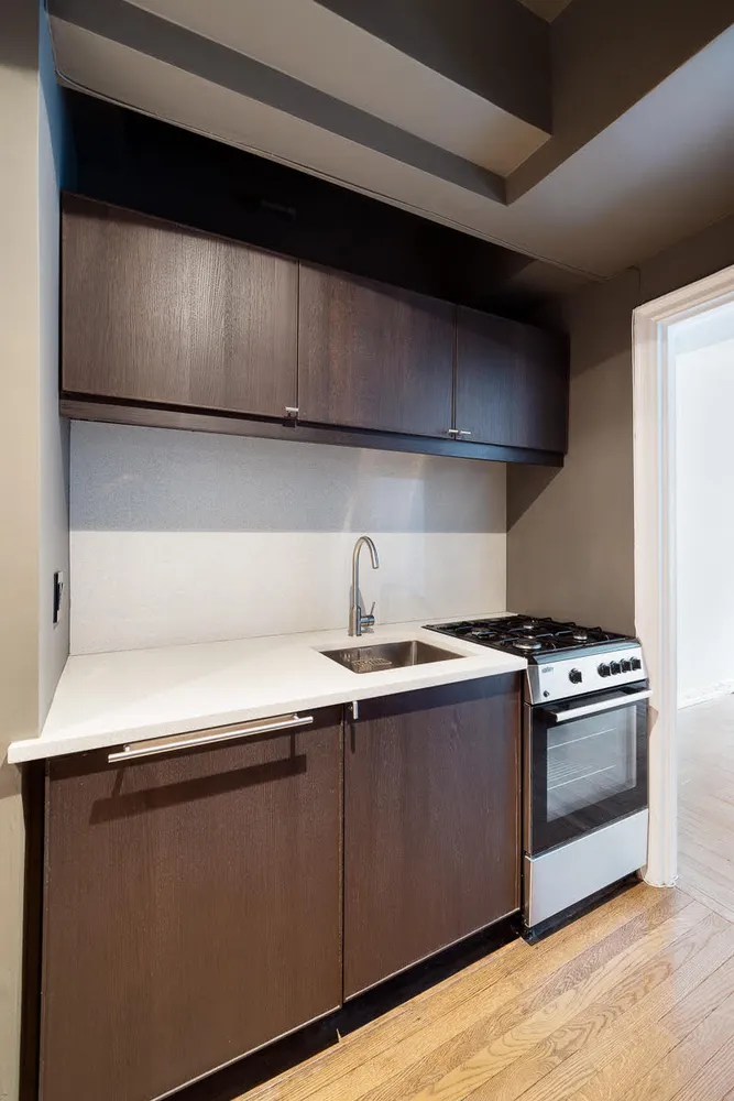 a kitchen with wooden cabinets and a stove top oven