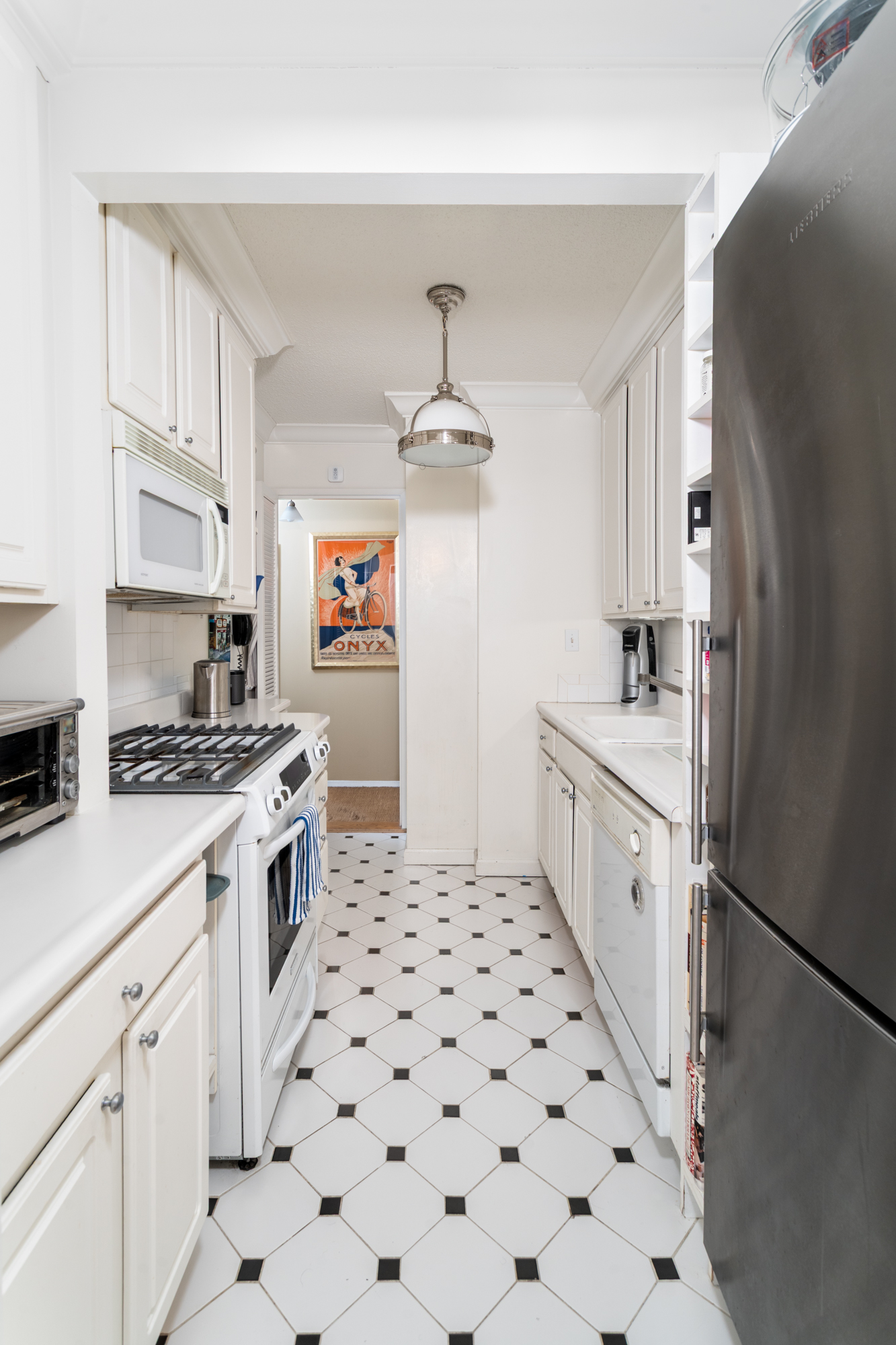 50 East 89th Street, Unit 31C Manhattan, NY 10128 - Photo 11 of 18 a kitchen with stainless steel appliances a refrigerator and a stove