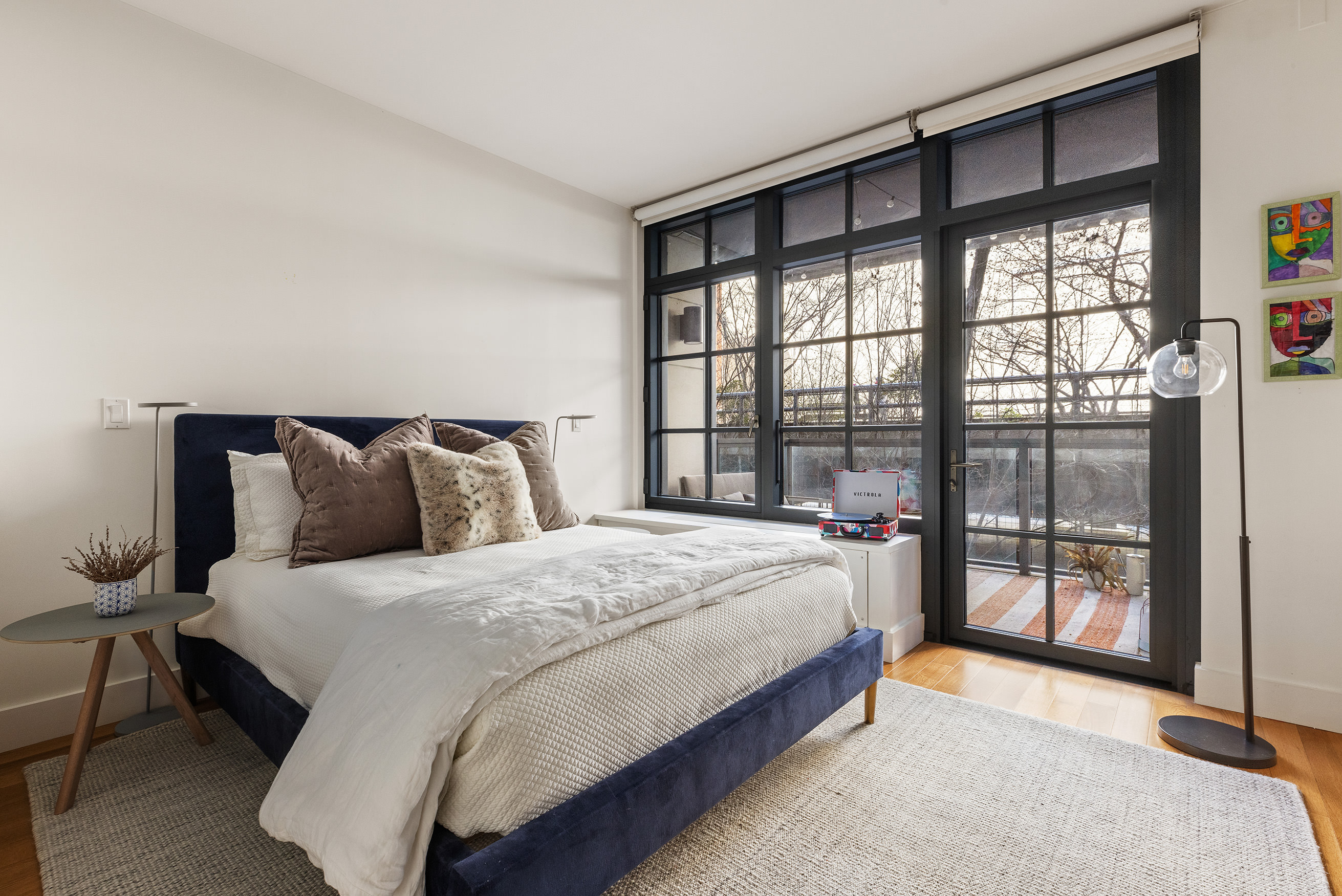 500 West 21st Street, Unit 3A Manhattan, NY 10011 - Photo 8 of 11 a large bed sitting in a bedroom next to a large window