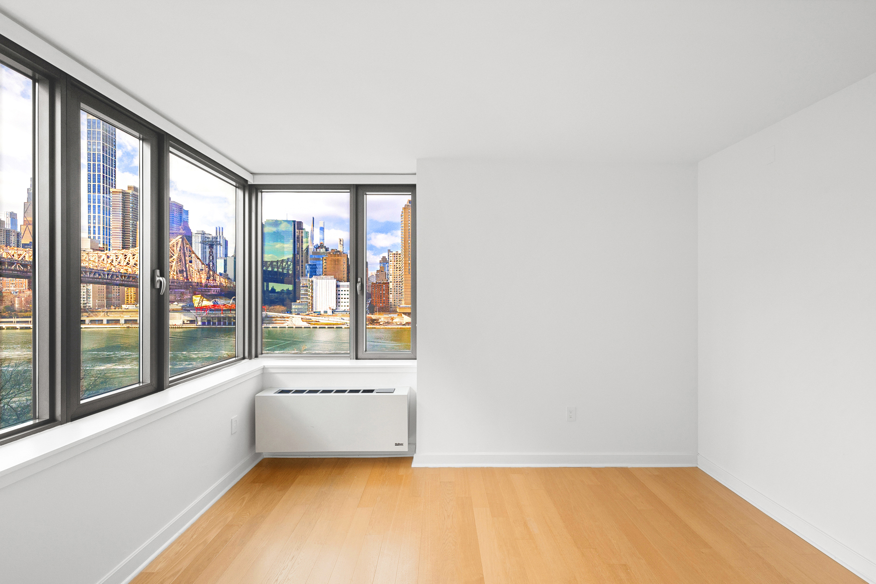 425 Main Street, Unit 9F Manhattan, NY 10044 - Photo 2 of 15 a view of an empty room with a window