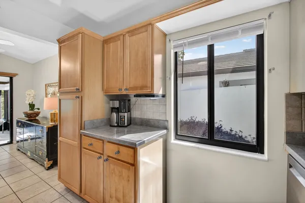 a kitchen with stainless steel appliances granite countertop a refrigerator and a stove