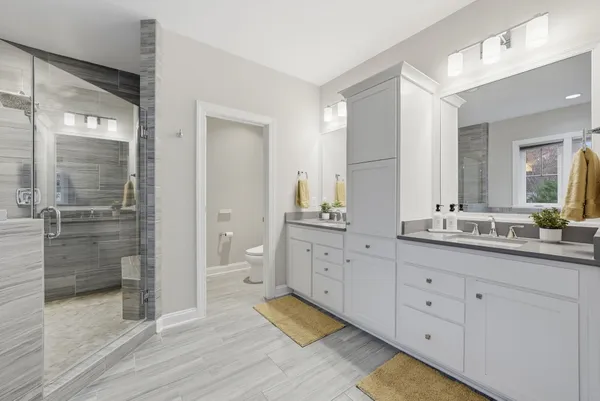 a spacious bedroom with a bed and a large window