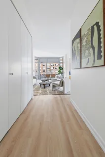 a view of a hallway with furniture and windows