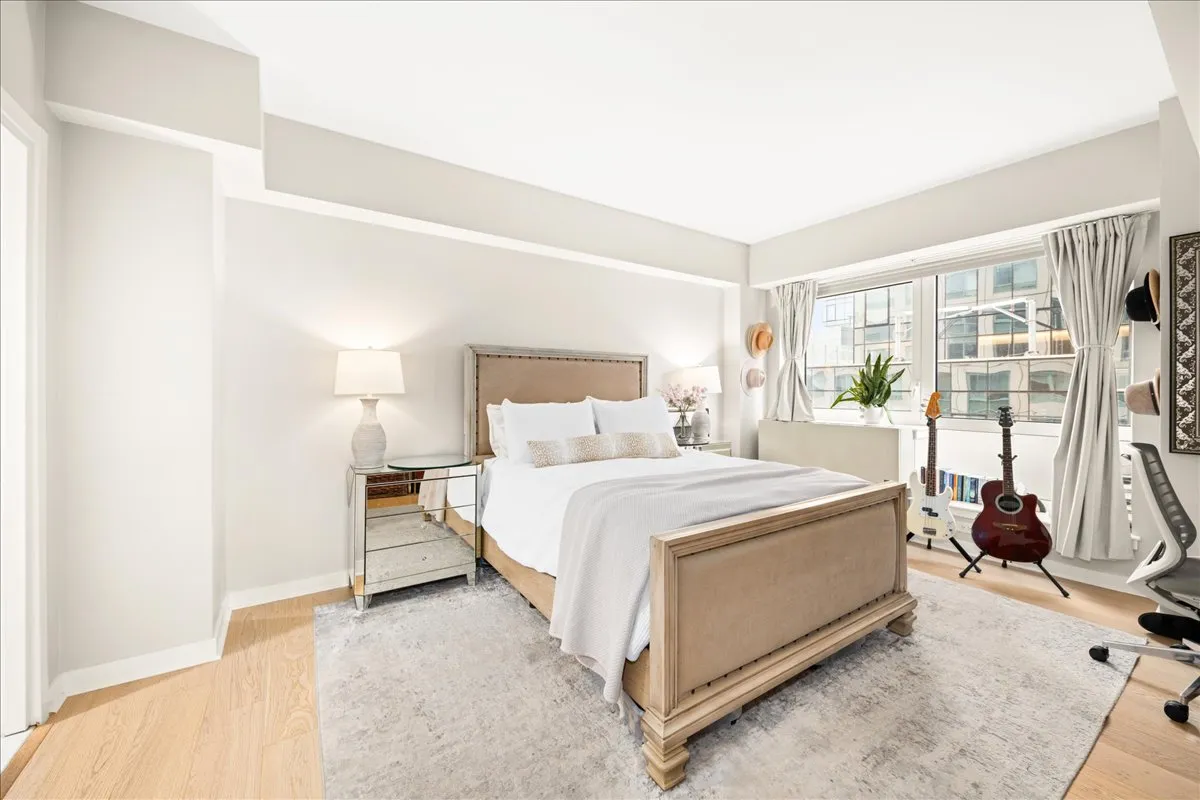 a bedroom with a bed and a large window