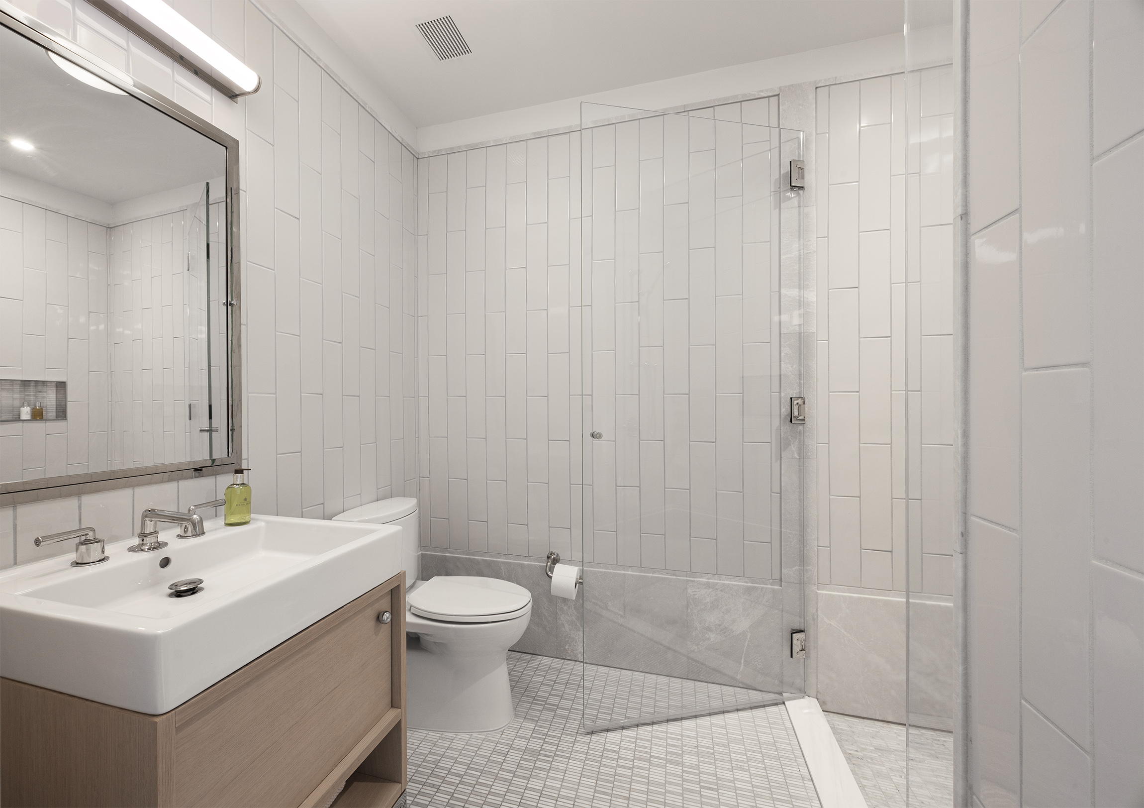 301 East 50th Street, Unit 16B Manhattan, NY 10022 - Photo 10 of 15 a bathroom with a sink a toilet and shower